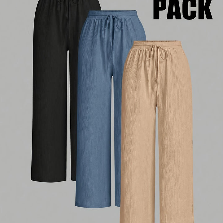 Three stylish pairs of comfortable women's trousers in black, blue, and beige with drawstring waists
