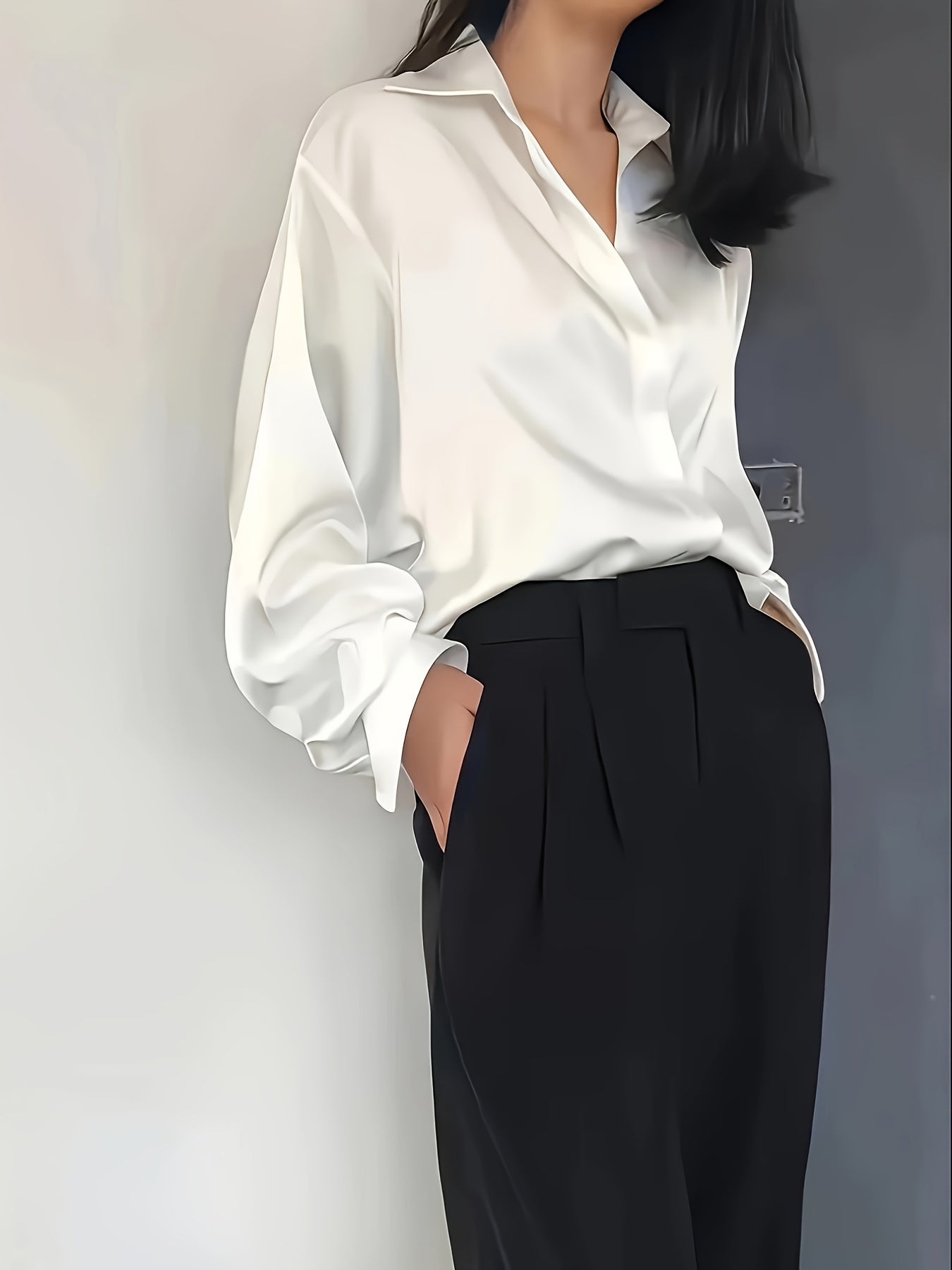 Elegant white blouse paired with tailored black trousers for formal workwear for women