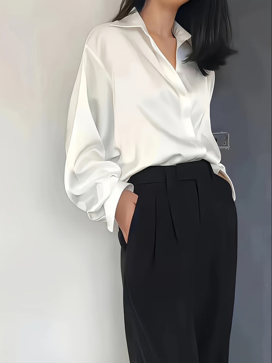 Elegant white blouse paired with tailored black trousers for formal workwear for women