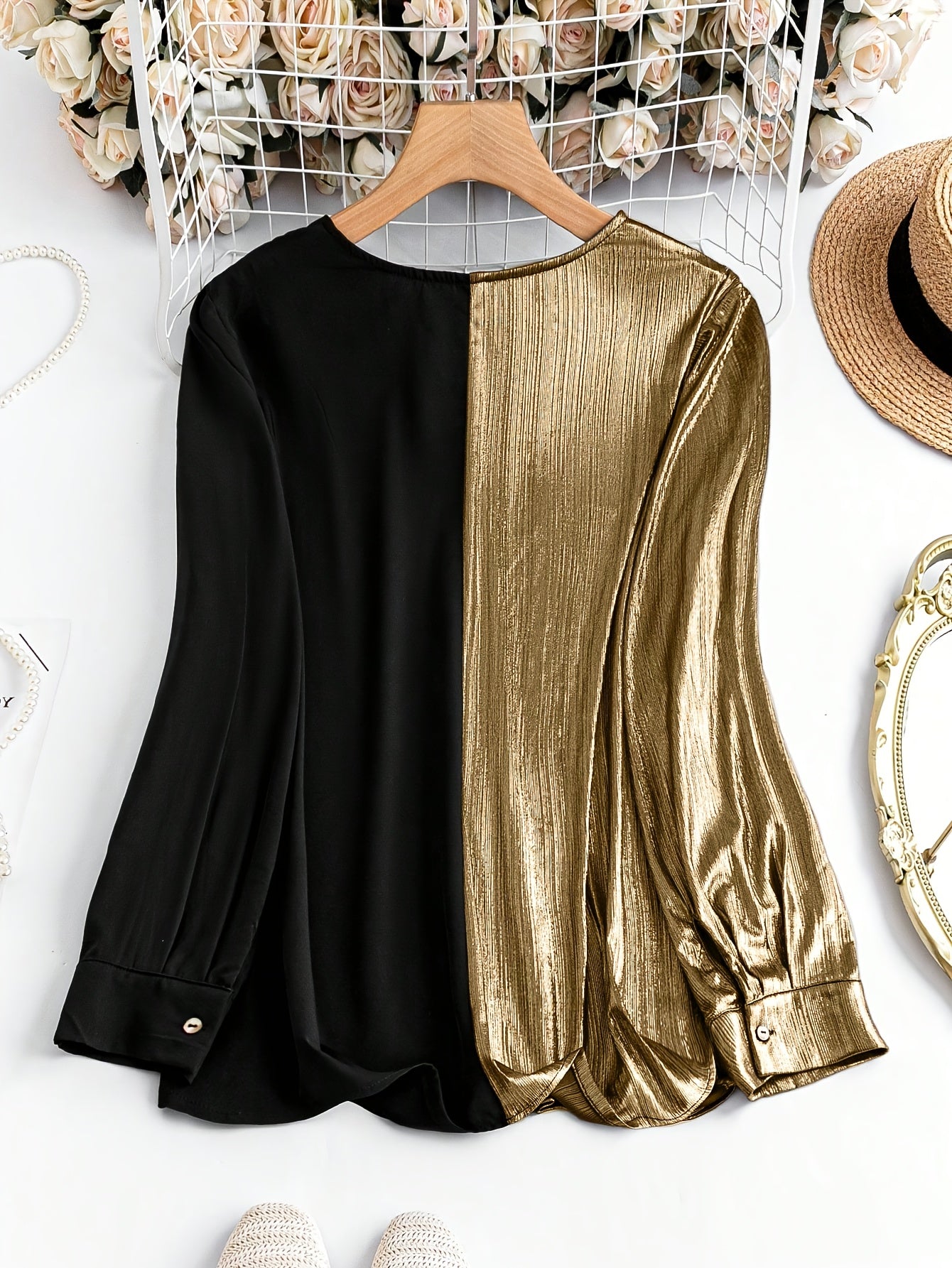 Gorgeous long sleeve top in black and gold with a stylish split design and buttoned cuffs