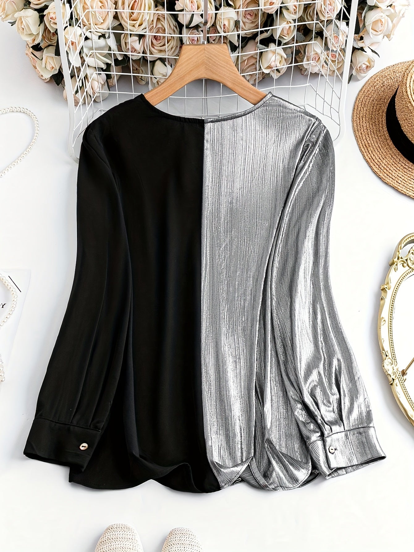 Gorgeous long sleeve top featuring a black and silver split design with stylish button details
