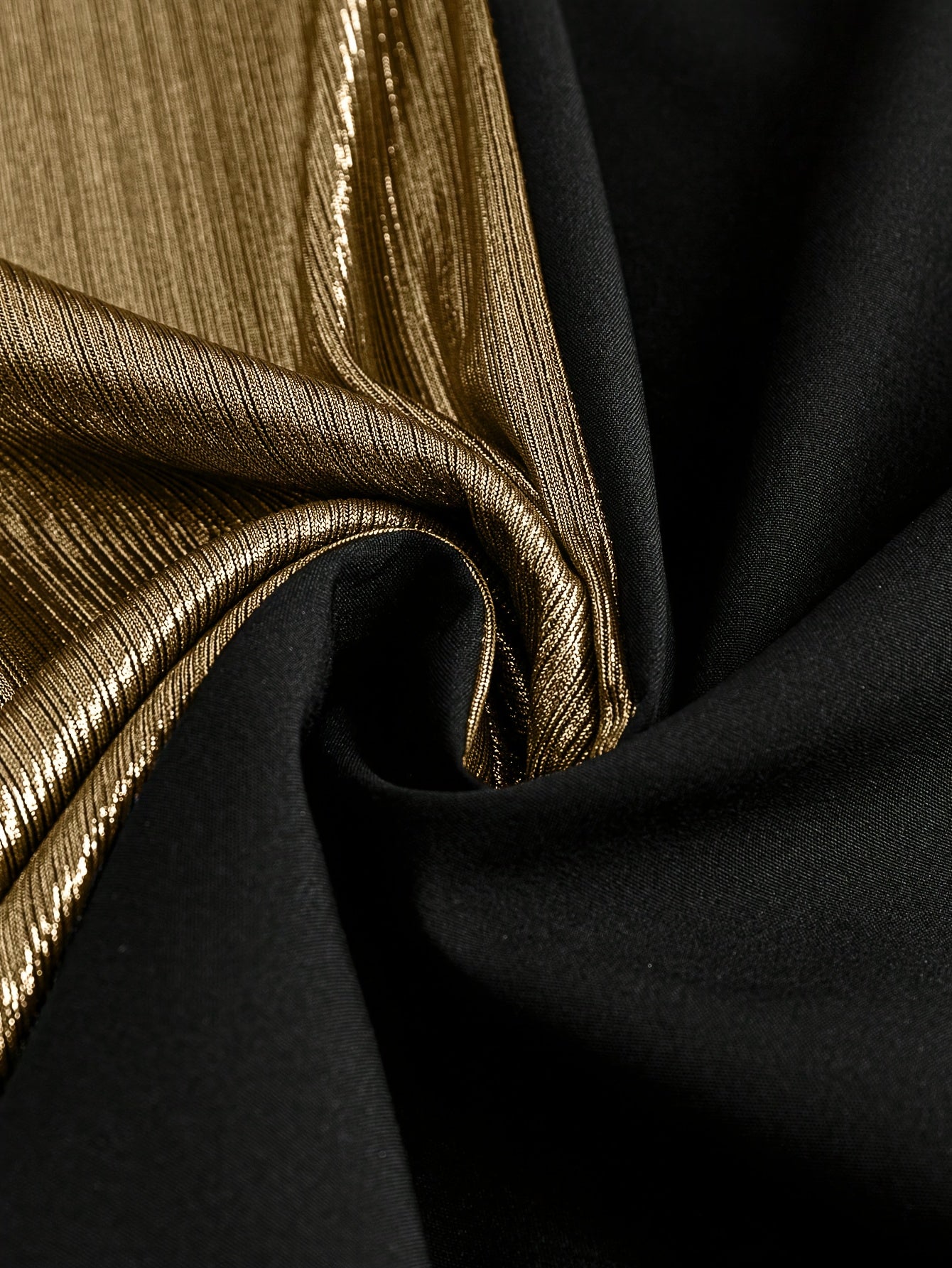 Gorgeous long sleeve top fabric close-up with black and gold textures for stylish clothing