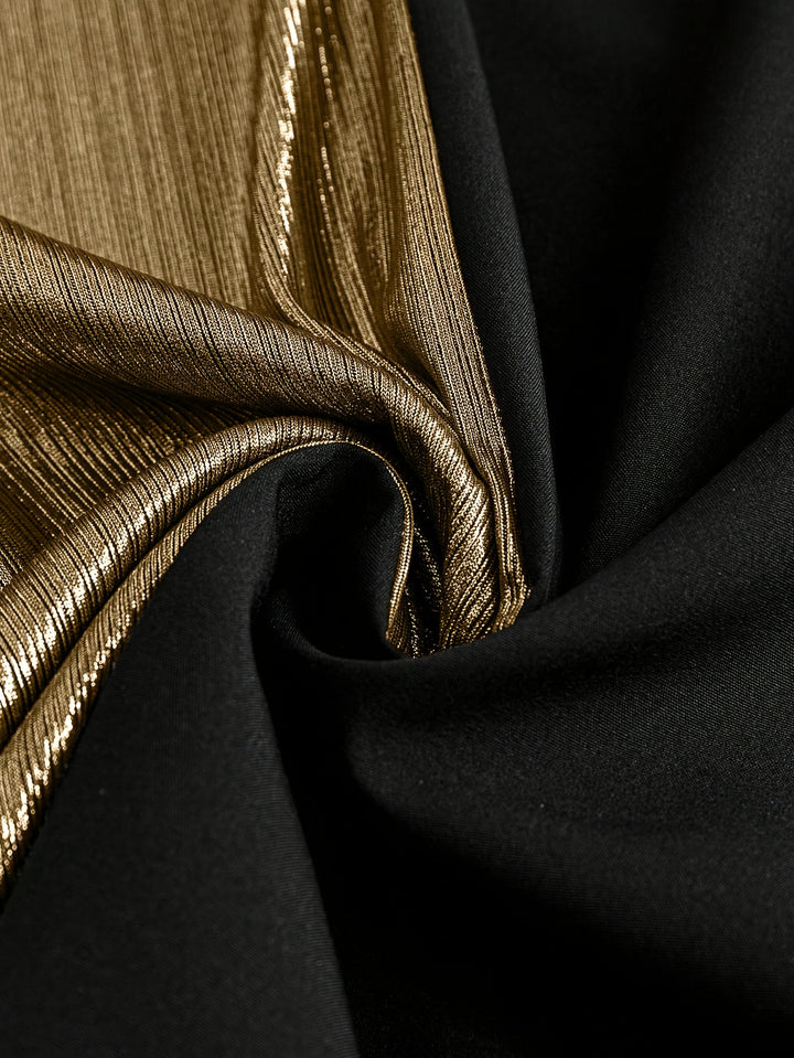 Gorgeous long sleeve top fabric close-up with black and gold textures for stylish clothing