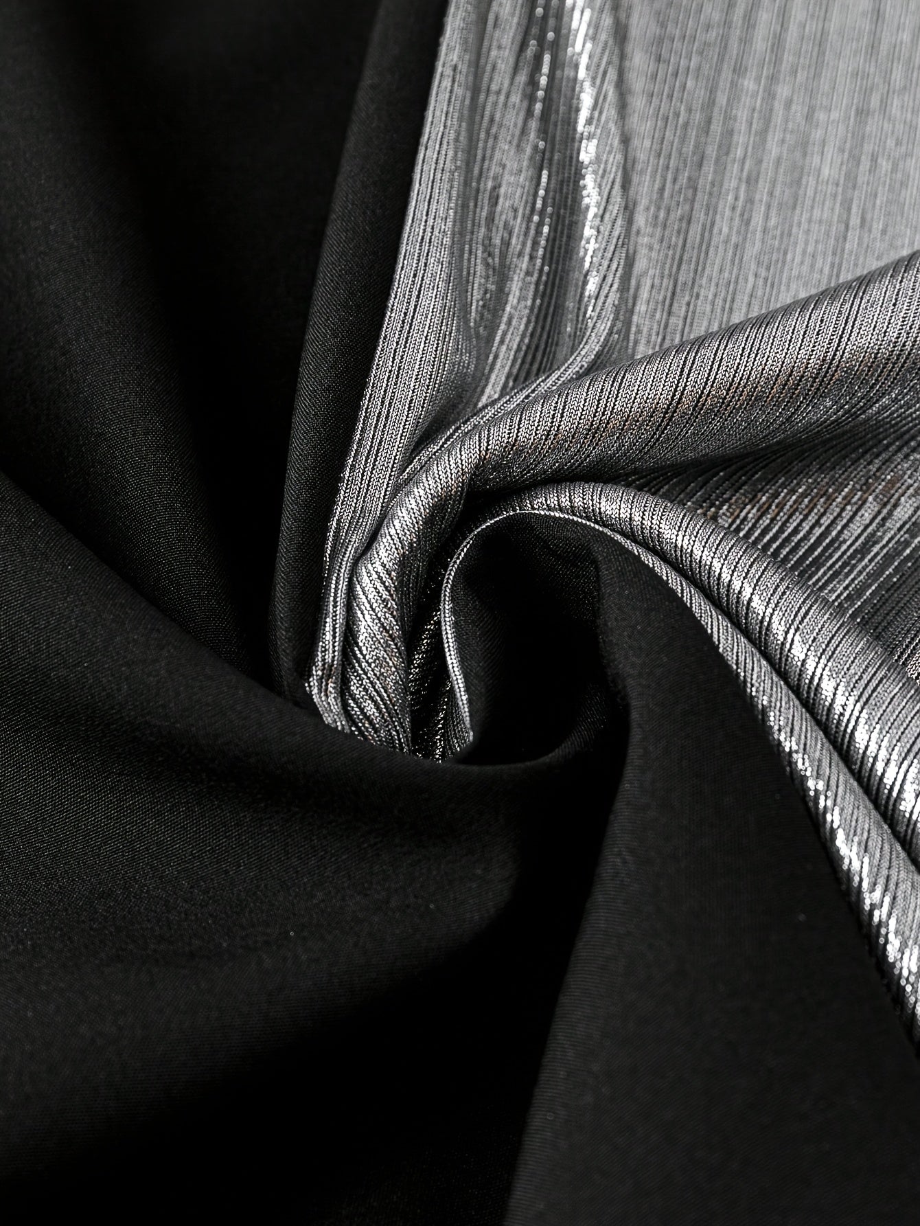 Close-up of fabric texture showcasing a Gorgeous long sleeve top with black and silver materials