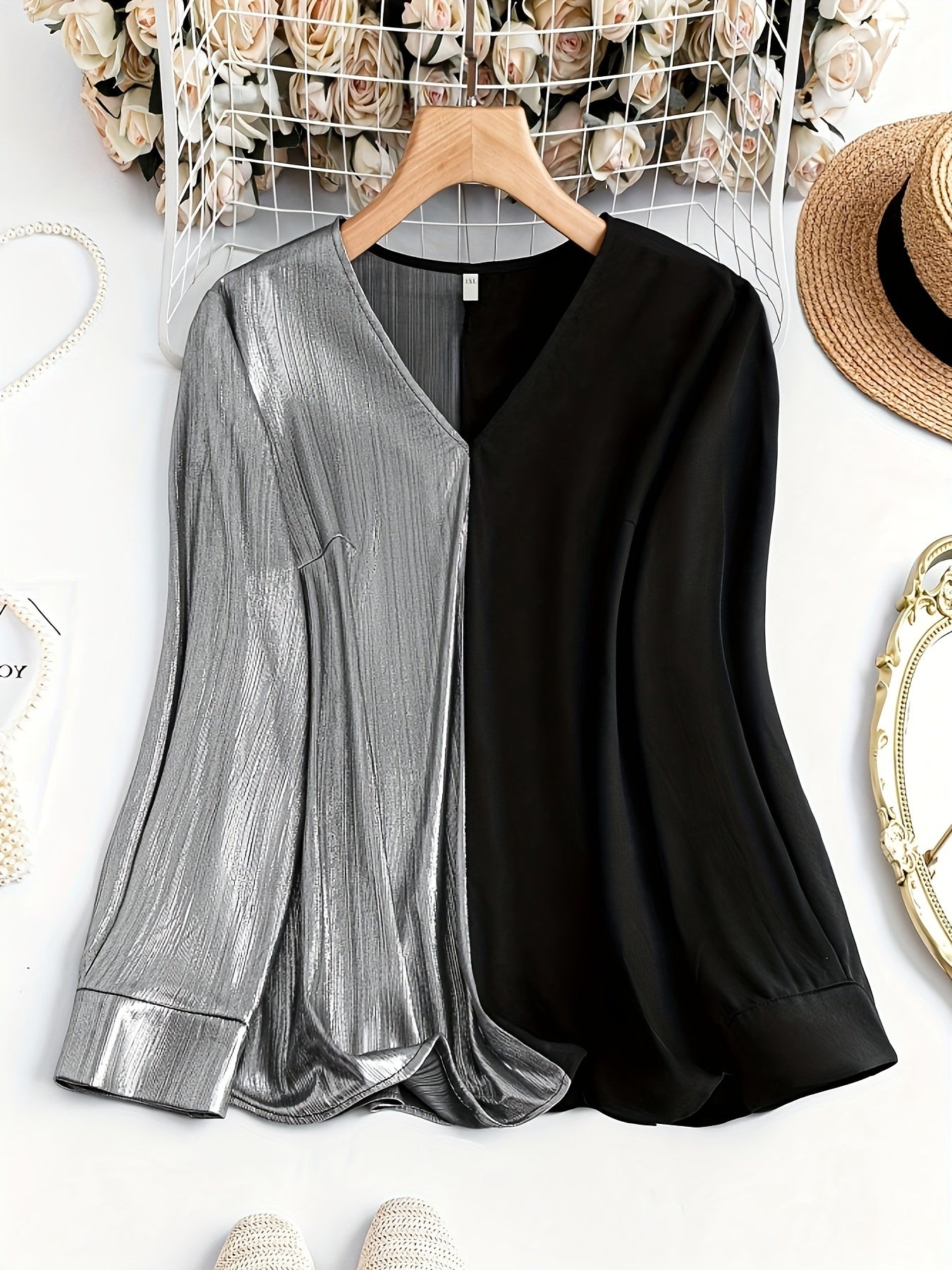 Gorgeous long sleeve top featuring a stylish black and silver split design with a v-neckline